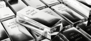 Stacked fine silver bars marked “999.9” and “1000g,” representing the high-purity silver recovered from recycled solar panels.