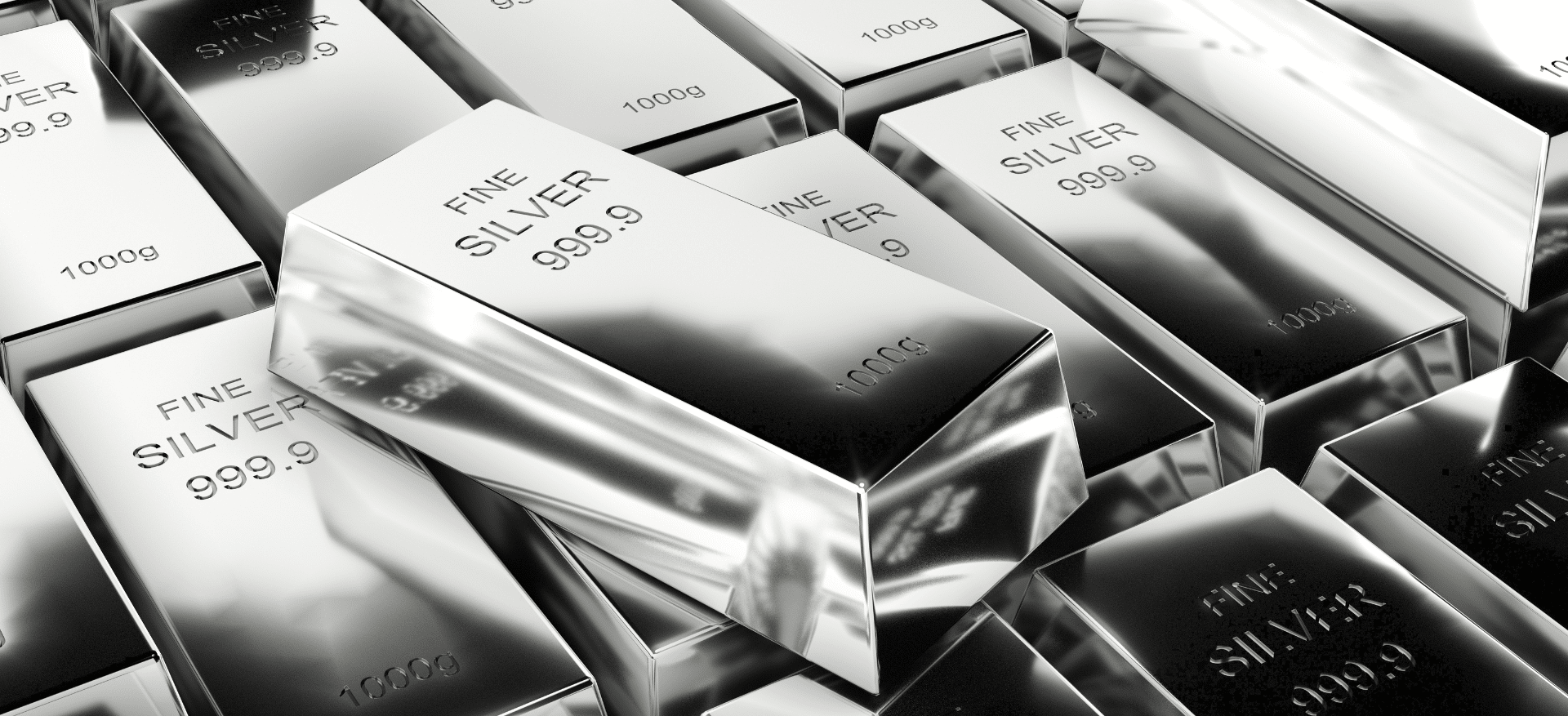 Stacked fine silver bars marked “999.9” and “1000g,” representing the high-purity silver recovered from recycled solar panels.
